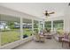 Bright sunroom with wicker furniture and water views at 117 Villa Dr # 117, Osprey, FL 34229