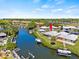 Aerial view showing canal-front property with boat dock and lush landscaping at 117 Villa Dr # 117, Osprey, FL 34229