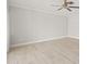 Spacious bedroom with ceiling fan and wood-look floors at 117 Villa Dr # 117, Osprey, FL 34229