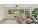 Bright sunroom with water views and wicker furniture at 117 Villa Dr # 117, Osprey, FL 34229