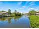 Peaceful waterfront view of a canal, with lush vegetation and boats at 117 Villa Dr # 117, Osprey, FL 34229