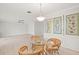 Bright dining area with glass-paned room divider and wicker chairs at 117 Villa Dr # 117, Osprey, FL 34229
