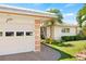Attached garage with two car capacity and decorative trim at 117 Villa Dr # 117, Osprey, FL 34229