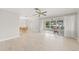 Spacious living room with light wood floors and sliding doors to patio at 117 Villa Dr # 117, Osprey, FL 34229