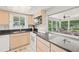 Kitchen with granite countertops and view of lanai at 117 Villa Dr # 117, Osprey, FL 34229