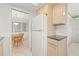 Kitchen with light wood cabinets, granite countertop, and view to dining area at 117 Villa Dr # 117, Osprey, FL 34229