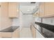 Kitchen with granite countertops and light wood cabinets at 117 Villa Dr # 117, Osprey, FL 34229