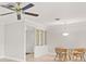 Bright dining room with glass-paned room divider and ceiling fan at 117 Villa Dr # 117, Osprey, FL 34229