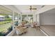 Relaxing sunroom with wicker furniture and water views at 117 Villa Dr # 117, Osprey, FL 34229