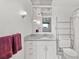 Bathroom features granite countertop and white cabinets at 117 Villa Dr # 117, Osprey, FL 34229