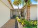 Screened porch entry with lush landscaping at 117 Villa Dr # 117, Osprey, FL 34229