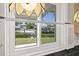 Kitchen window view overlooking a canal with boats and waterfront homes at 117 Villa Dr # 117, Osprey, FL 34229