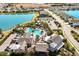 Aerial view of community pool, clubhouse, and lake at 14538 Barefoot Ln, Parrish, FL 34219