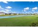Community lakefront view with lush landscaping and homes at 14538 Barefoot Ln, Parrish, FL 34219