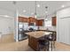 Modern kitchen with stainless steel appliances, granite countertops, and dark wood cabinets at 14538 Barefoot Ln, Parrish, FL 34219