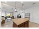 Open kitchen features granite island, looking into living room at 14538 Barefoot Ln, Parrish, FL 34219