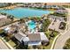 Aerial view of community pool, clubhouse, and lake at 14538 Barefoot Ln, Parrish, FL 34219