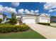 White two-story house with a two-car garage and landscaping at 14538 Barefoot Ln, Parrish, FL 34219