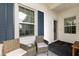 Relaxing front porch with wicker chairs and a small table, featuring blue shutters at 14538 Barefoot Ln, Parrish, FL 34219