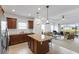 Open kitchen with island, stainless steel appliances, and view into living room at 14538 Barefoot Ln, Parrish, FL 34219