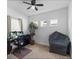 Bright home office with a large desk, comfortable chair, and a plant at 14538 Barefoot Ln, Parrish, FL 34219