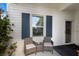 Front porch with wicker chairs, a small table, and blue shutters at 14538 Barefoot Ln, Parrish, FL 34219
