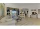 Spacious living room with large windows, elegant furnishings, and access to a pool at 1509 Raphis Royale Blvd, Englewood, FL 34223