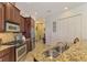 Well-equipped kitchen with granite counters and stainless steel appliances at 1509 Raphis Royale Blvd, Englewood, FL 34223