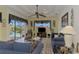 Living room boasts a ceiling fan and pool access at 1509 Raphis Royale Blvd, Englewood, FL 34223