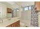 Bathroom with a shower/tub combo and wood vanity at 1509 Raphis Royale Blvd, Englewood, FL 34223