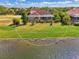 Aerial view of a single Gathering home with pool and lake access at 1509 Raphis Royale Blvd, Englewood, FL 34223