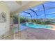 Inviting screened pool and spa with a glass-top table at 1509 Raphis Royale Blvd, Englewood, FL 34223