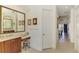 Bathroom with large vanity, mirror and access to bedroom at 1509 Raphis Royale Blvd, Englewood, FL 34223