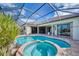 Expansive pool and spa with a covered patio at 1509 Raphis Royale Blvd, Englewood, FL 34223