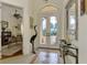 Bright entryway with double doors and view to the living room at 1509 Raphis Royale Blvd, Englewood, FL 34223