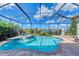 Stunning screened pool and spa with a tranquil view at 1509 Raphis Royale Blvd, Englewood, FL 34223