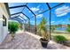 Screened patio with tranquil lake views and lush landscaping at 1509 Raphis Royale Blvd, Englewood, FL 34223