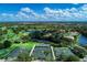 Aerial view of community tennis courts and golf course at 1509 Raphis Royale Blvd, Englewood, FL 34223