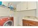 Laundry room with washer, dryer, and cabinets at 1509 Raphis Royale Blvd, Englewood, FL 34223
