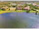 Aerial view of a lakefront community with numerous homes and landscaping at 1509 Raphis Royale Blvd, Englewood, FL 34223