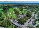 Aerial view showing golf course, clubhouse, and tennis courts at 1509 Raphis Royale Blvd, Englewood, FL 34223