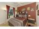 King sized bed in a themed bedroom with dark red walls at 1509 Raphis Royale Blvd, Englewood, FL 34223