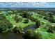 Aerial view of golf course and pond at 1509 Raphis Royale Blvd, Englewood, FL 34223