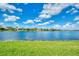 Beautiful lakefront property with clear water and sunny skies at 1509 Raphis Royale Blvd, Englewood, FL 34223