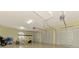 Spacious three-car garage with high ceilings and ample storage at 1509 Raphis Royale Blvd, Englewood, FL 34223