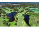 Aerial view of golf course with lakes and lush landscaping at 1509 Raphis Royale Blvd, Englewood, FL 34223