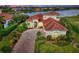 Luxury home with lake views and a brick driveway at 1509 Raphis Royale Blvd, Englewood, FL 34223
