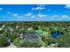 Aerial view of tennis courts and surrounding landscape at 1509 Raphis Royale Blvd, Englewood, FL 34223