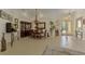 Bright dining room with a chandelier and large windows at 1509 Raphis Royale Blvd, Englewood, FL 34223