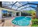 Relaxing pool and spa with covered patio and lake view at 1509 Raphis Royale Blvd, Englewood, FL 34223